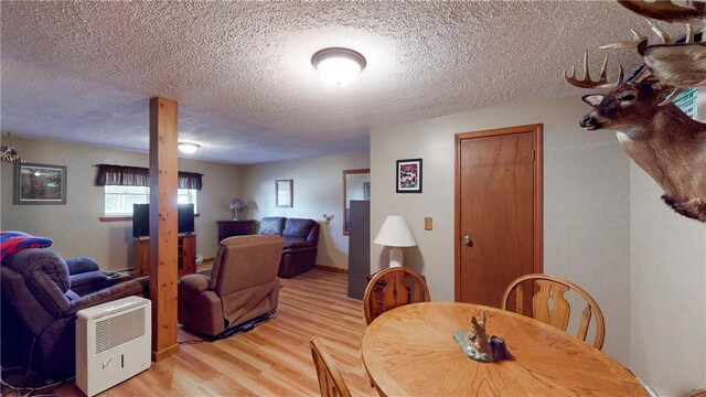 6 Club View Dr, Bath, NY 14810 - dining space featuring light wood-style floors and a textured ceiling