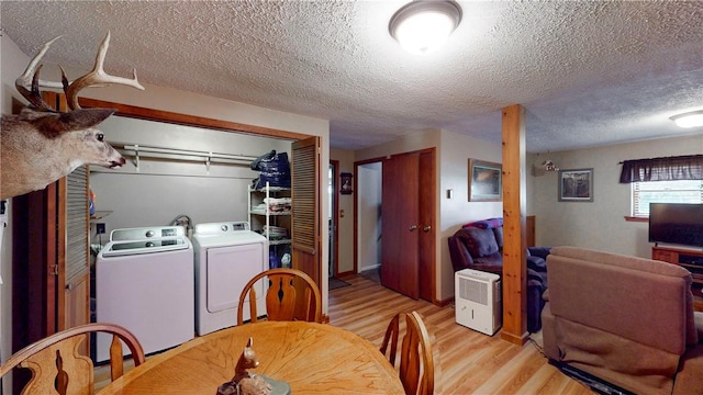 6 Club View Dr, Bath, NY 14810 - dining room featuring light wood-type flooring, a textured ceiling, and washer and dryer