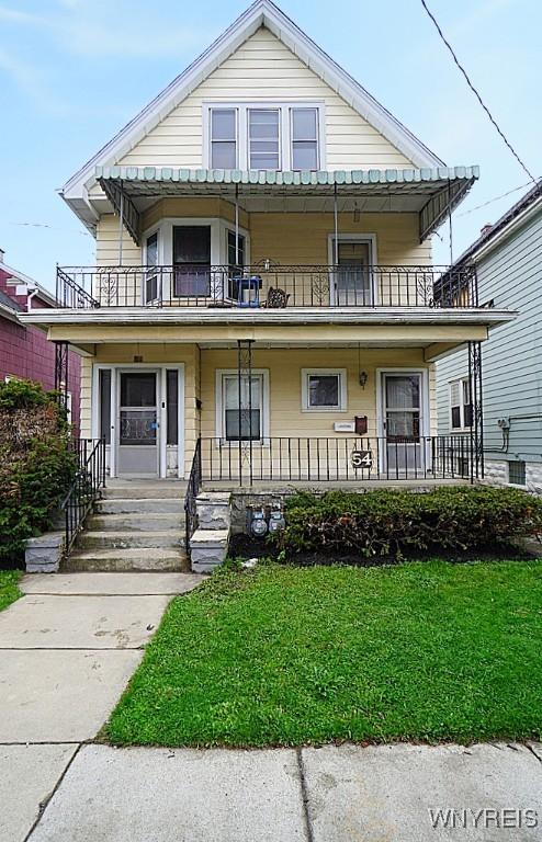 54 Pine Ridge Rd, Cheektowaga, NY 14211 - view of front of house featuring a balcony, a porch, and a front lawn