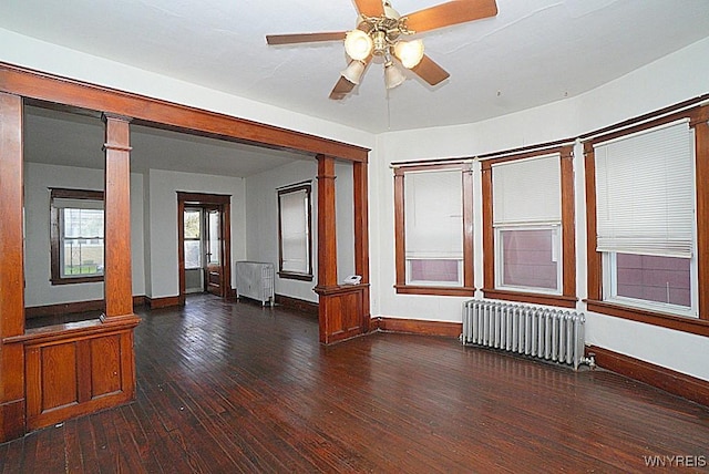 54 Pine Ridge Rd, Cheektowaga, NY 14211 - empty room featuring radiator, ornate columns, hardwood / wood-style floors, and ceiling fan