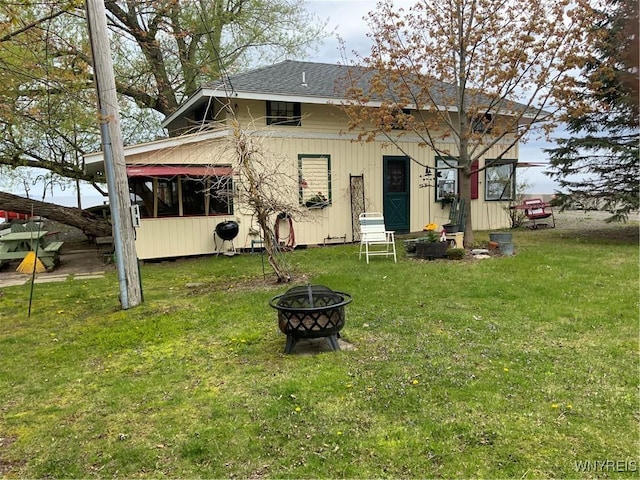 13202 Park Rd, Carlton, NY 14571 - rear view of property with a fire pit, a yard, and a shingled roof