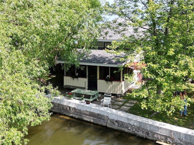 13202 Park Rd, Carlton, NY 14571 - back of house with a water view, a shingled roof, and a sunroom