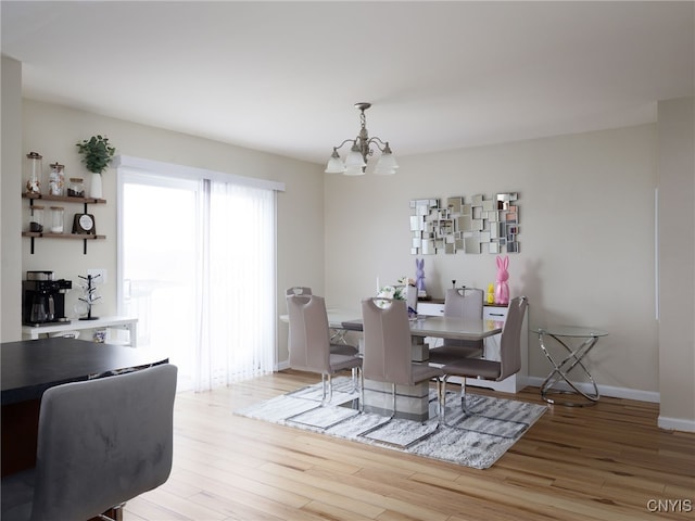 10029-10033 Ash St, Pamelia, NY 13601 - dining space with a chandelier, light wood-style flooring, and baseboards