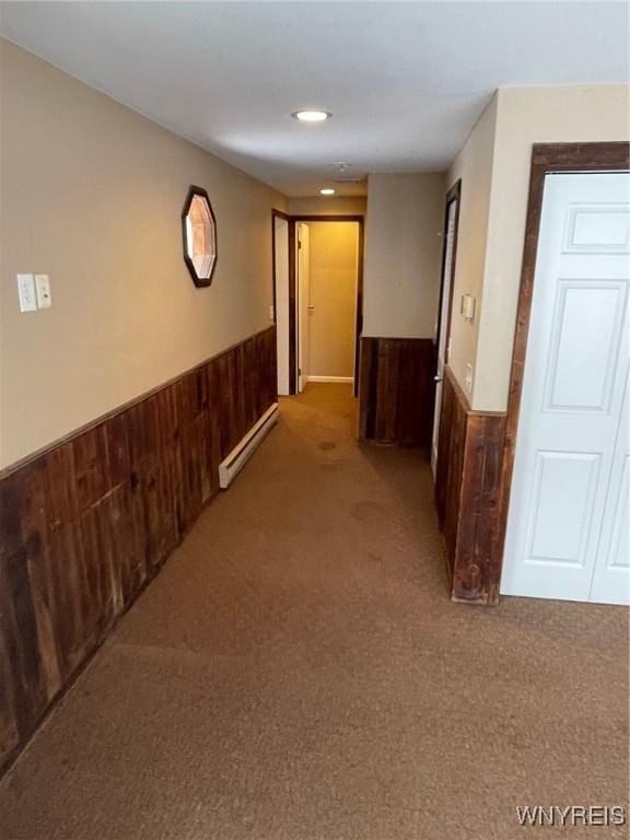 1068 Meiser Rd, Alabama, NY 14036 - hall with a baseboard radiator, a wainscoted wall, carpet flooring, wooden walls, and recessed lighting