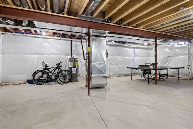 unfinished below grade area with electric water heater and heating unit