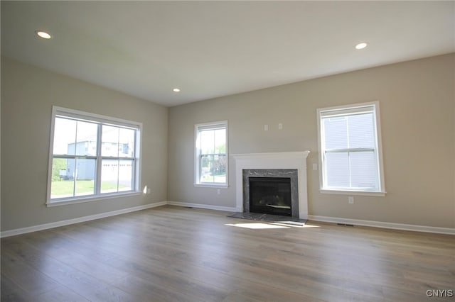 522 Chenango Hill Dr, Hamilton, NY 13346 - unfurnished living room featuring a premium fireplace, wood finished floors, baseboards, and recessed lighting