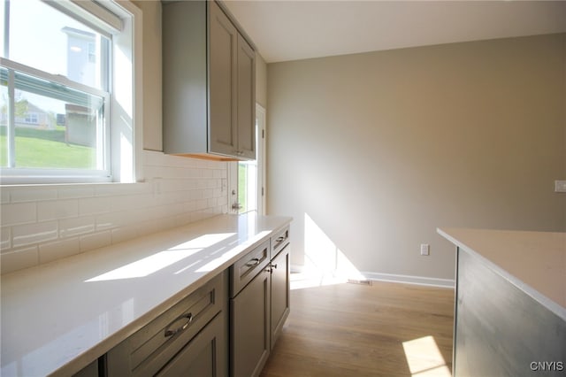 522 Chenango Hill Dr, Hamilton, NY 13346 - kitchen with decorative backsplash, light wood-type flooring, light countertops, and gray cabinets