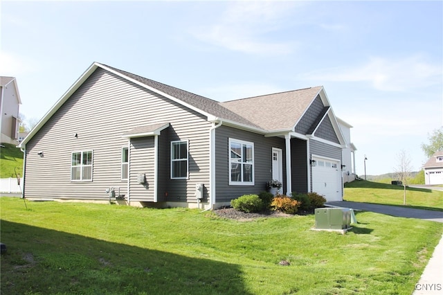 522 Chenango Hill Dr, Hamilton, NY 13346 - view of front facade featuring a front lawn, driveway, a garage, and a shingled roof