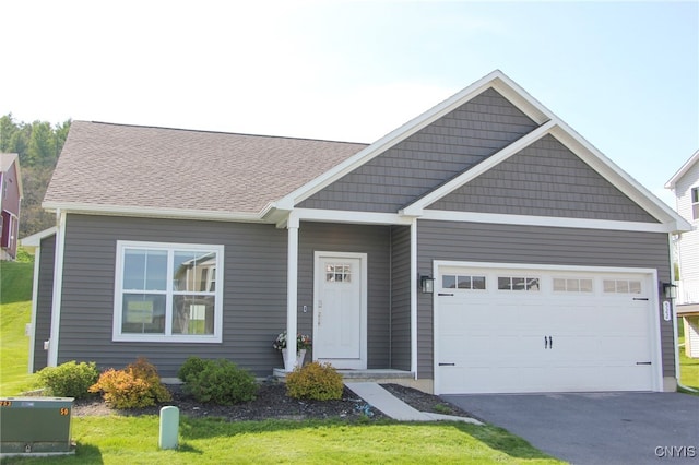 522 Chenango Hill Dr, Hamilton, NY 13346 - view of front of house with asphalt driveway, a garage, and a front lawn