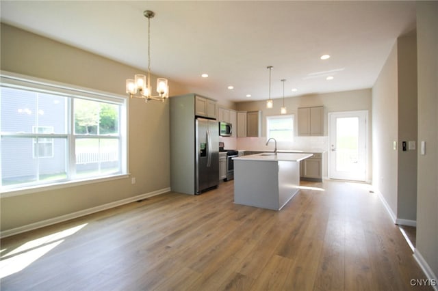 522 Chenango Hill Dr, Hamilton, NY 13346 - kitchen featuring stainless steel appliances, a chandelier, a sink, a kitchen island with sink, and light countertops