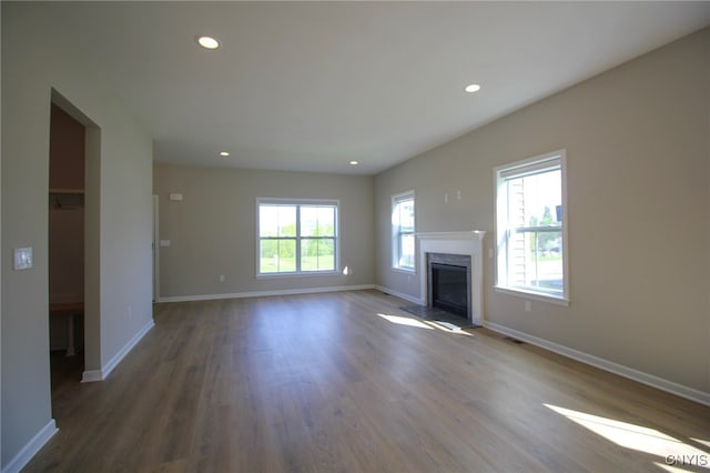 522 Chenango Hill Dr, Hamilton, NY 13346 - unfurnished living room featuring recessed lighting, baseboards, wood finished floors, and a premium fireplace