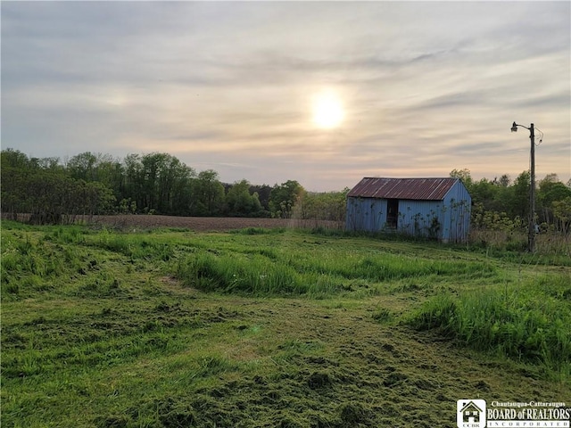 584 Warren Rd, Carroll, NY 14738 - view of yard featuring an outbuilding, an outdoor structure, and a view of countryside