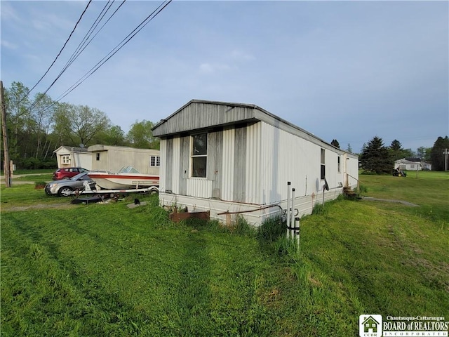 584 Warren Rd, Carroll, NY 14738 - view of home's exterior featuring a lawn