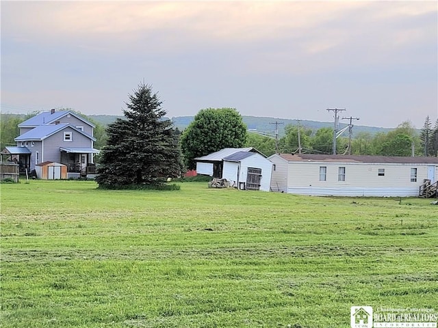 584 Warren Rd, Carroll, NY 14738 - view of grassy yard featuring an outbuilding and a storage shed