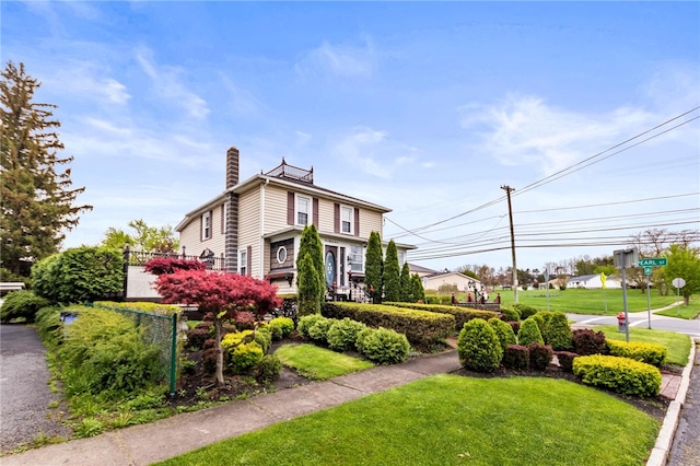 187 Clark St, Canandaigua-City, NY 14424 - view of front facade featuring a chimney and a front yard