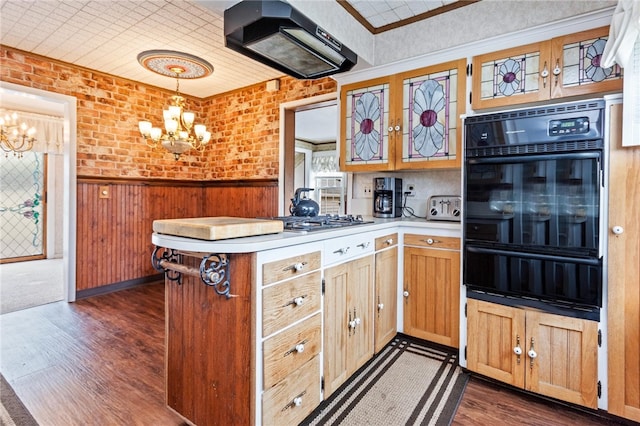 187 Clark St, Canandaigua-City, NY 14424 - kitchen featuring a warming drawer, black oven, a chandelier, ventilation hood, and a wainscoted wall