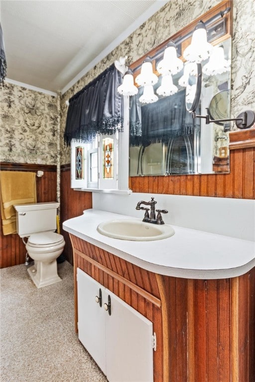 187 Clark St, Canandaigua-City, NY 14424 - bathroom with wallpapered walls, toilet, vanity, wainscoting, and ornamental molding