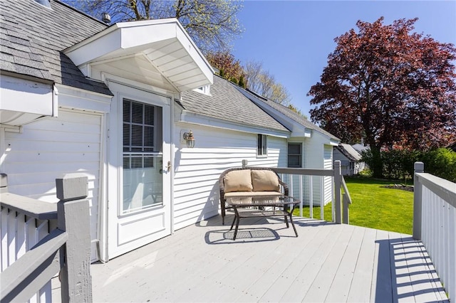 wooden deck with a lawn