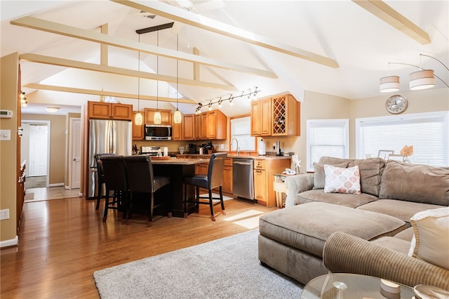 living area with light wood-style flooring and baseboards