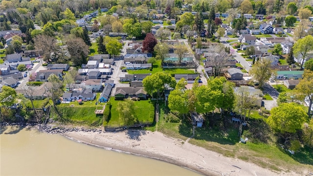 aerial view of property's location featuring nearby suburban area and a large body of water