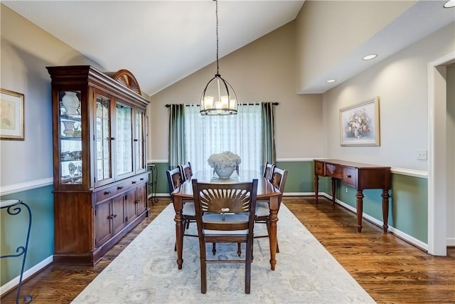 dining area featuring a chandelier, lofted ceiling, dark wood-style flooring, baseboards, and recessed lighting