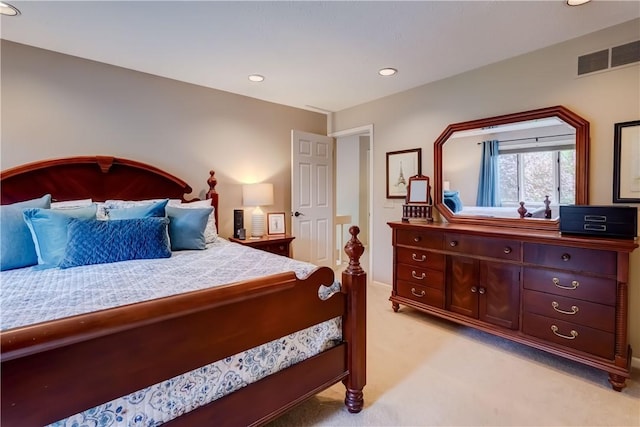 bedroom with light colored carpet, recessed lighting, and baseboards