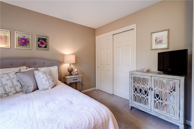 carpeted bedroom with a closet and baseboards
