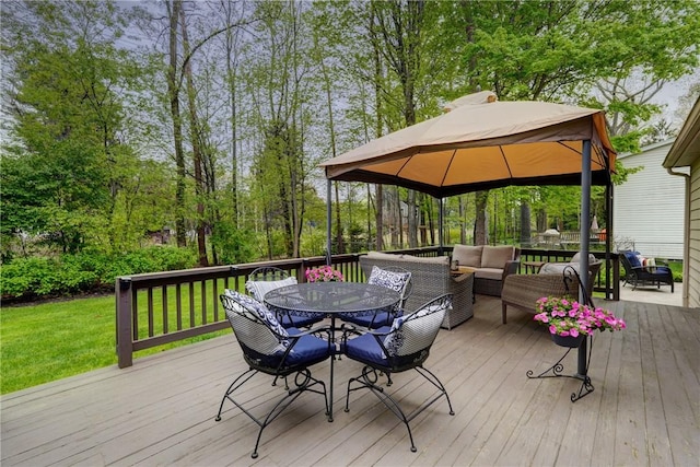 wooden terrace featuring a gazebo, outdoor lounge area, outdoor dining space, and a yard