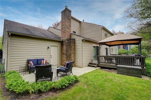rear view of house featuring an outdoor hangout area, a gazebo, a chimney, a yard, and a deck