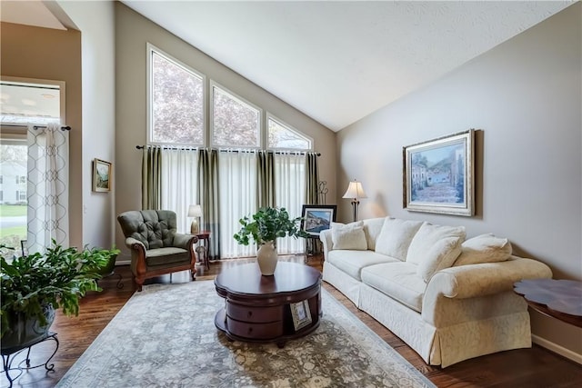 living room with vaulted ceiling, baseboards, and dark wood-style floors