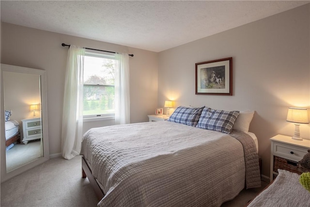 bedroom with light carpet and a textured ceiling