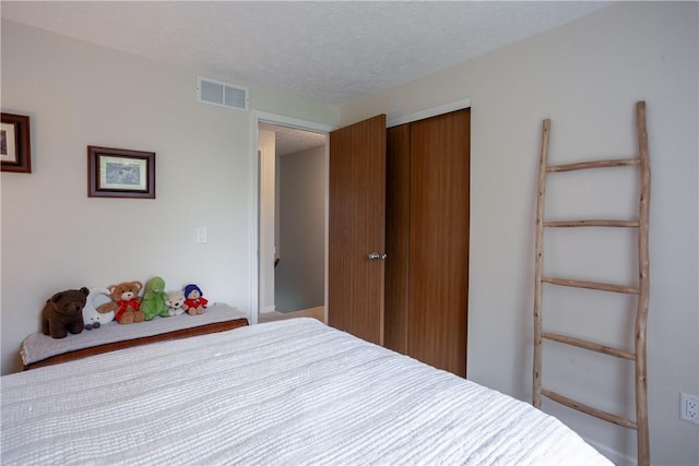 bedroom featuring a closet and a textured ceiling