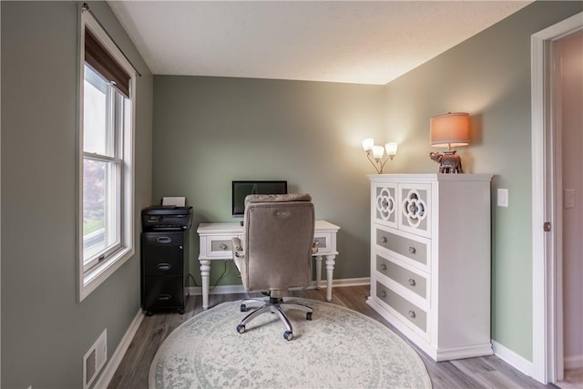home office with wood finished floors and baseboards