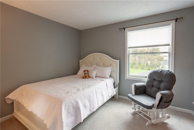 bedroom featuring carpet flooring and baseboards