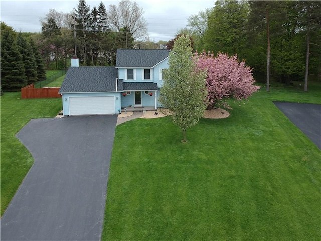 traditional home featuring driveway, a shingled roof, and a garage