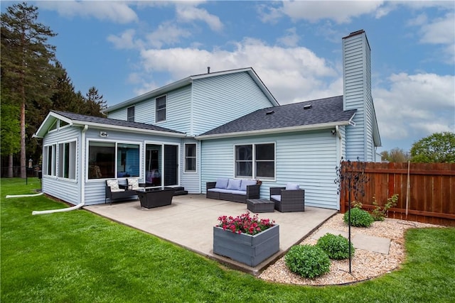 back of house with an outdoor living space, a patio area, and a chimney