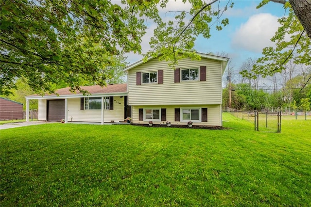 tri-level home with an attached garage, concrete driveway, and a gate