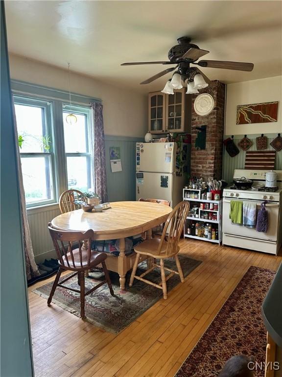 923 Teall Ave, Syracuse, NY 13206 - dining space with ceiling fan, wainscoting, and wood-type flooring