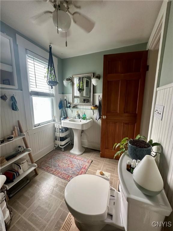 923 Teall Ave, Syracuse, NY 13206 - bathroom with ceiling fan and a wainscoted wall
