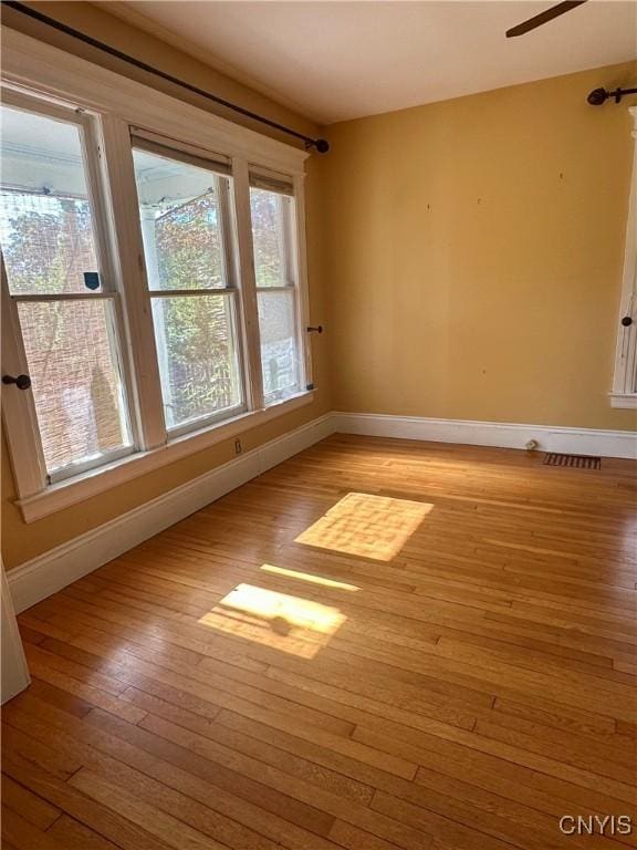 923 Teall Ave, Syracuse, NY 13206 - unfurnished room with light wood-style flooring, healthy amount of natural light, and ceiling fan