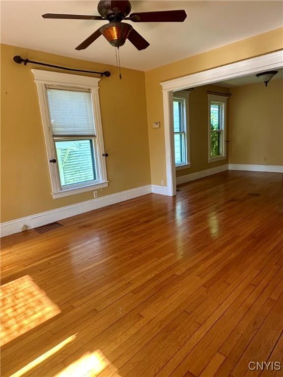 923 Teall Ave, Syracuse, NY 13206 - unfurnished room featuring wood finished floors and ceiling fan