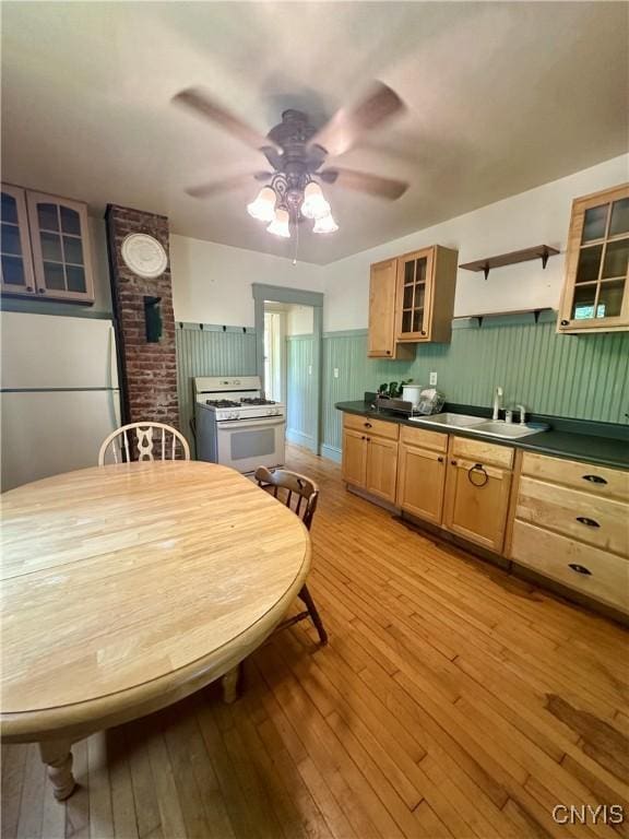 923 Teall Ave, Syracuse, NY 13206 - kitchen featuring gas range gas stove, freestanding refrigerator, dark countertops, a ceiling fan, and light wood finished floors