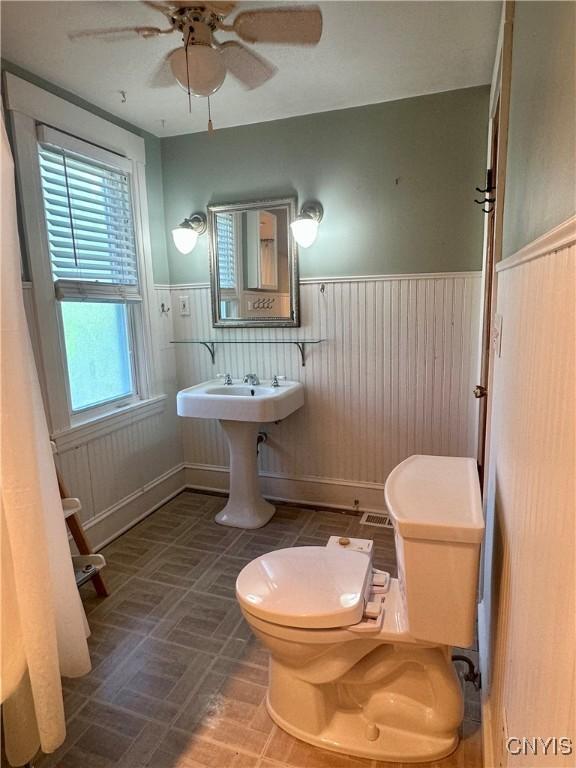 923 Teall Ave, Syracuse, NY 13206 - bathroom featuring wainscoting and ceiling fan