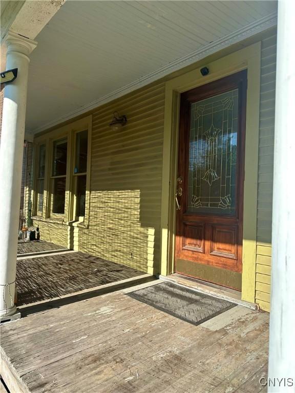 923 Teall Ave, Syracuse, NY 13206 - doorway to property featuring covered porch and brick siding