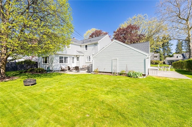 back of house with a fire pit and a patio area