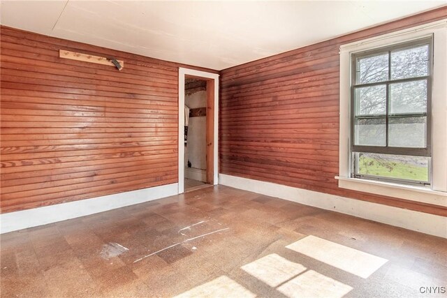 37931 State Route 12e, Clayton, NY 13624 - unfurnished room featuring tile patterned floors and wooden walls