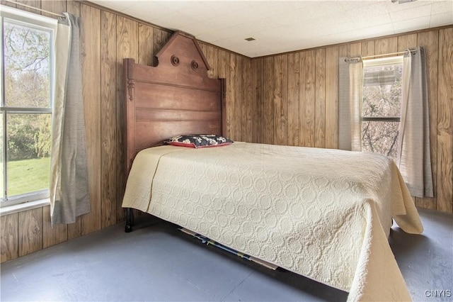 37931 State Route 12e, Clayton, NY 13624 - bedroom featuring wood walls, multiple windows, and concrete flooring