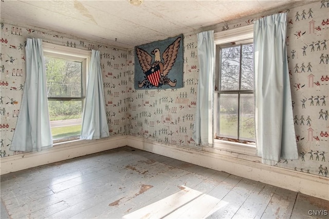 37931 State Route 12e, Clayton, NY 13624 - empty room featuring wallpapered walls and wood-type flooring