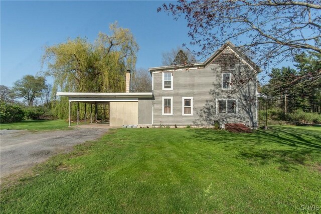 37931 State Route 12e, Clayton, NY 13624 - view of home's exterior with driveway, an attached carport, and a lawn