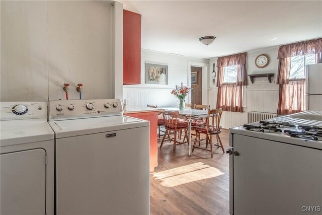 37931 State Route 12e, Clayton, NY 13624 - laundry area with washer / dryer, radiator, and light wood finished floors